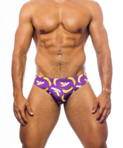 Men's swimwear, briefs style, worn by a man, front view, pattern with a design of yellow bananas of different sizes, partially peeled, on a purple background