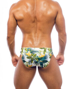 Men's swimwear, slip style, worn by a man, rear view, green floral pattern with some yellow flowers