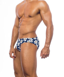 Men's swimwear, slip style, worn by a man, side view, white daisy print on a blue background.
