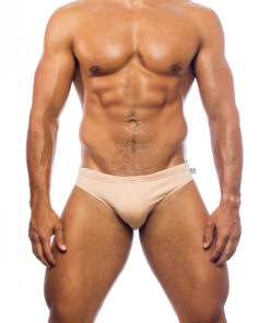 Men's swimwear, briefs style, worn by a man, front view, sand color background.