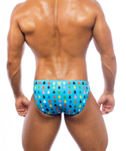 Men's swimwear, slip style, worn by a man, rear view, all-over colorful droplets pattern on a light blue background.