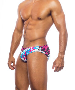 Men's swimwear, slip style, worn by a man, side view, camouflage pattern with blue, pink, white and brown colors.
