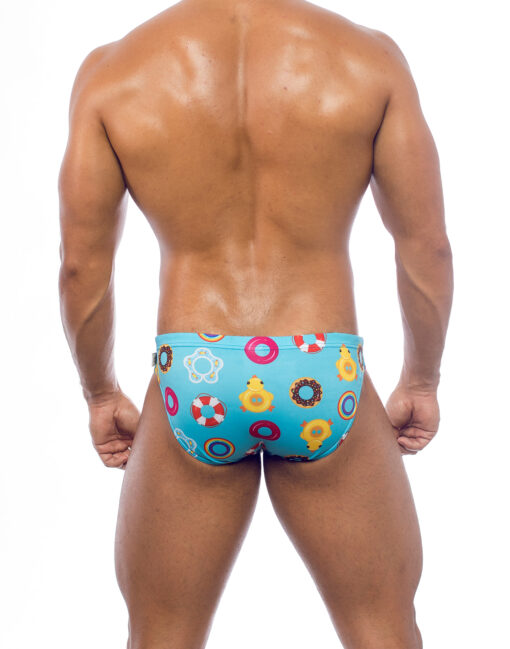 Men's swimwear, slip style, worn by a man, rear view, design of inflatable sea toys on a blue background.