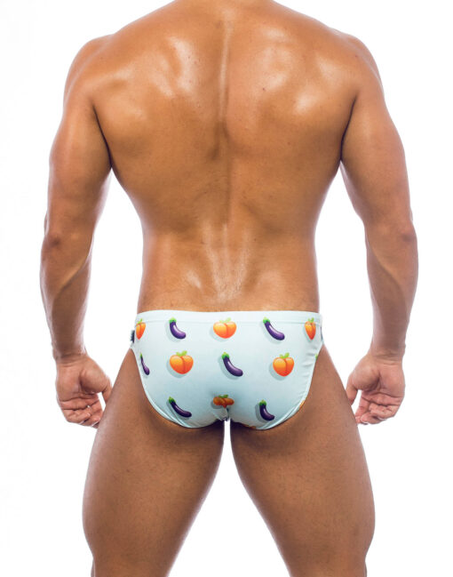 Men's swimwear, slip model, worn by a man, rear view, with a print of a design featuring a peach and an eggplant on a light blue background